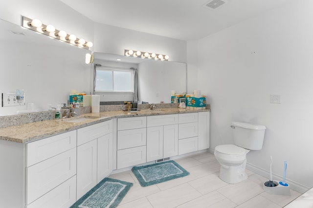 bathroom featuring tile patterned flooring, vanity, and toilet