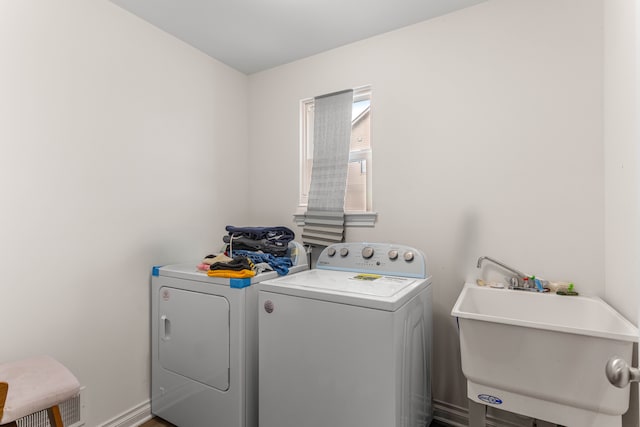 washroom featuring independent washer and dryer and sink