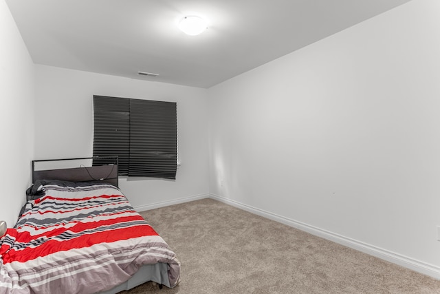 bedroom featuring light carpet