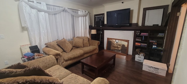 living room with wood-type flooring and ornamental molding