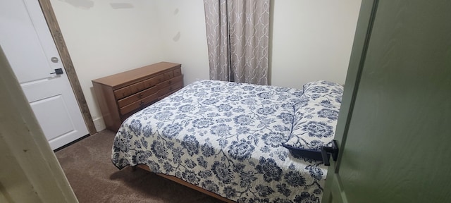 bedroom featuring dark colored carpet