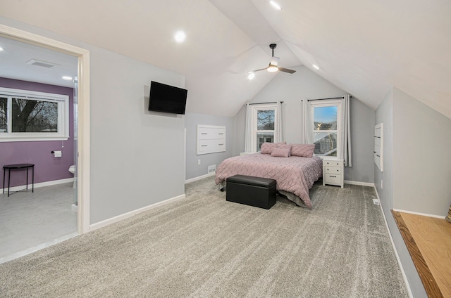 bedroom with ceiling fan, ensuite bath, lofted ceiling, and carpet flooring