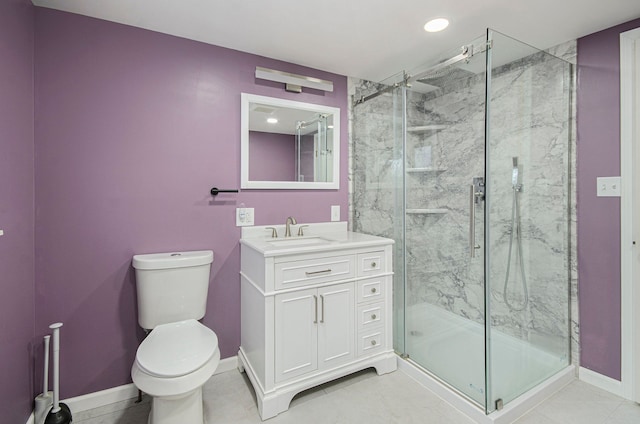 bathroom featuring toilet, tile patterned flooring, walk in shower, and vanity