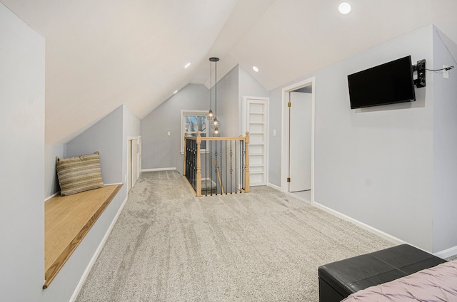 additional living space featuring vaulted ceiling, carpet, and built in features