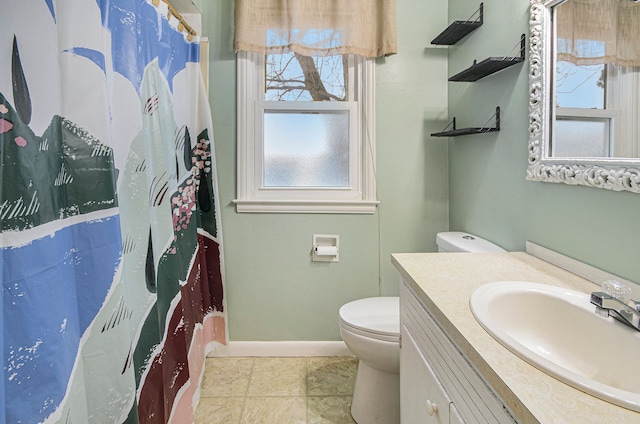 bathroom with toilet, tile patterned flooring, curtained shower, and vanity