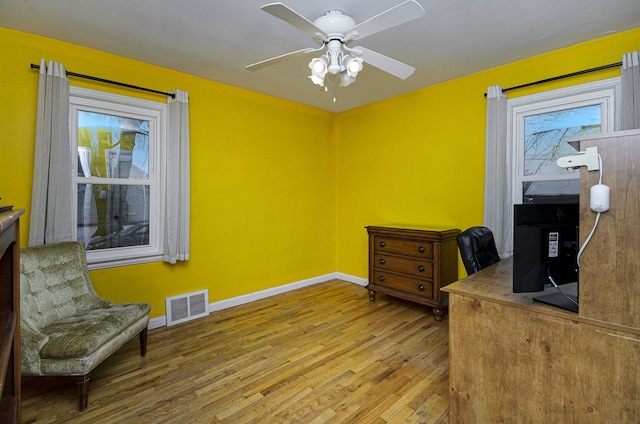 office featuring wood-type flooring and ceiling fan