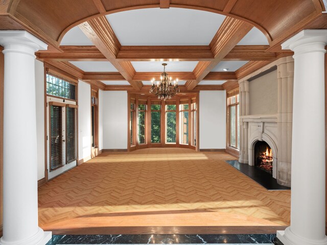 hall featuring coffered ceiling, crown molding, light parquet floors, a notable chandelier, and beam ceiling