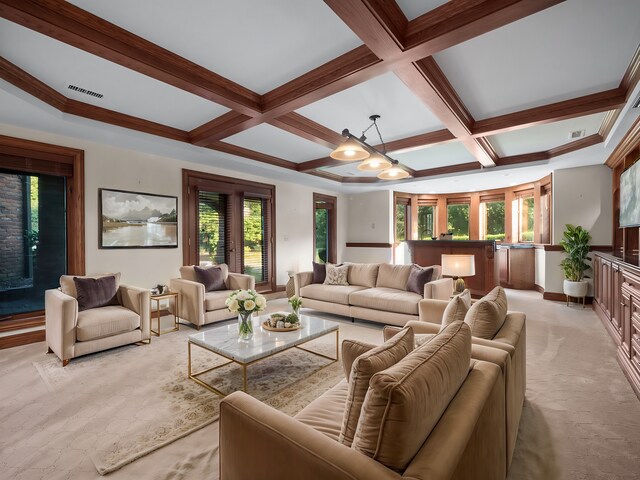 carpeted living room with beamed ceiling, a notable chandelier, and coffered ceiling