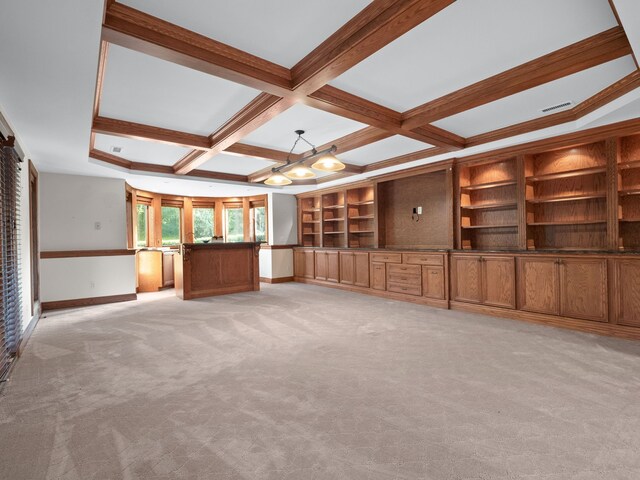 unfurnished living room with coffered ceiling, light carpet, crown molding, beamed ceiling, and built in shelves