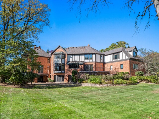 back of house with a lawn