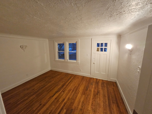 interior space with dark hardwood / wood-style floors and a textured ceiling