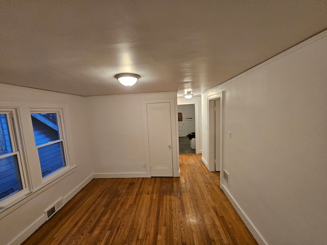 empty room with hardwood / wood-style flooring