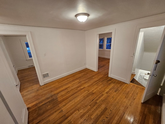 unfurnished bedroom featuring hardwood / wood-style flooring