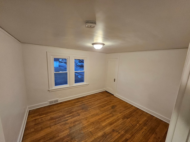 empty room with dark hardwood / wood-style floors