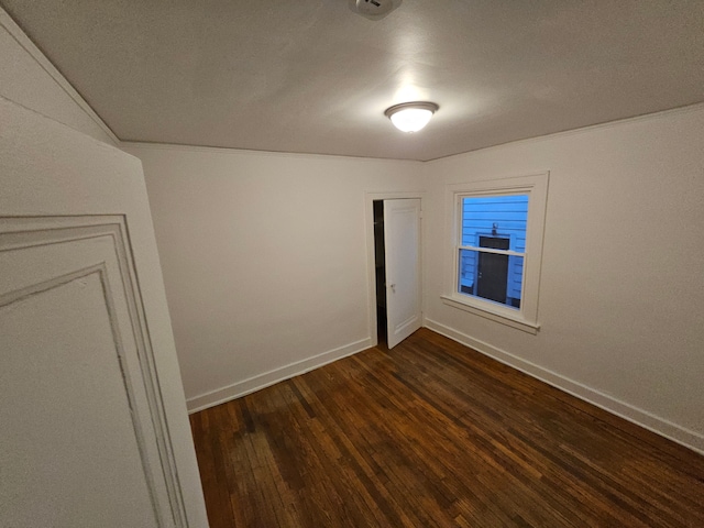 unfurnished room with dark hardwood / wood-style floors