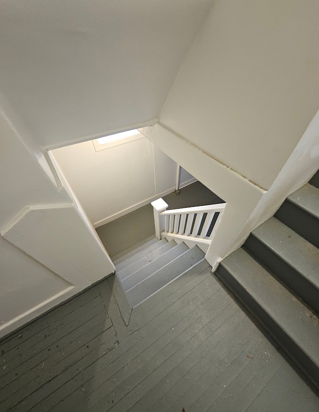 stairs featuring hardwood / wood-style flooring