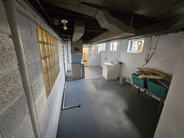 basement with heating unit and washing machine and clothes dryer