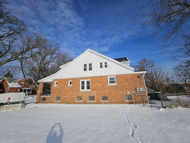 view of snow covered back of property