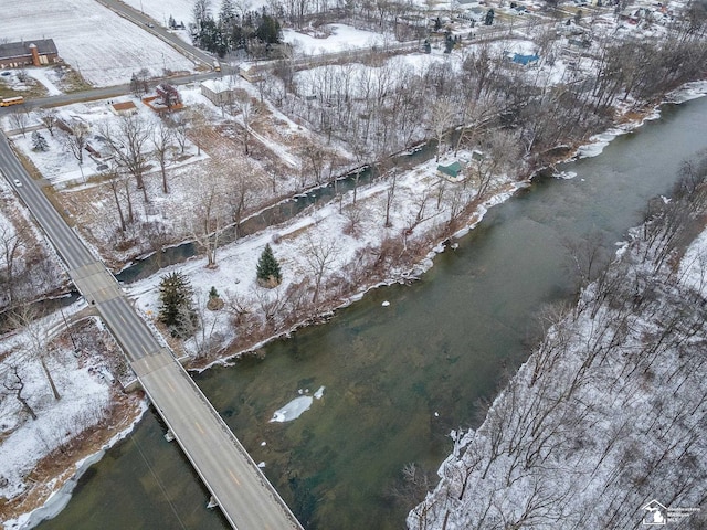 snowy aerial view with a water view