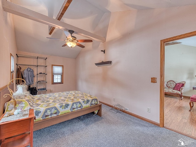 carpeted bedroom featuring lofted ceiling with beams and ceiling fan