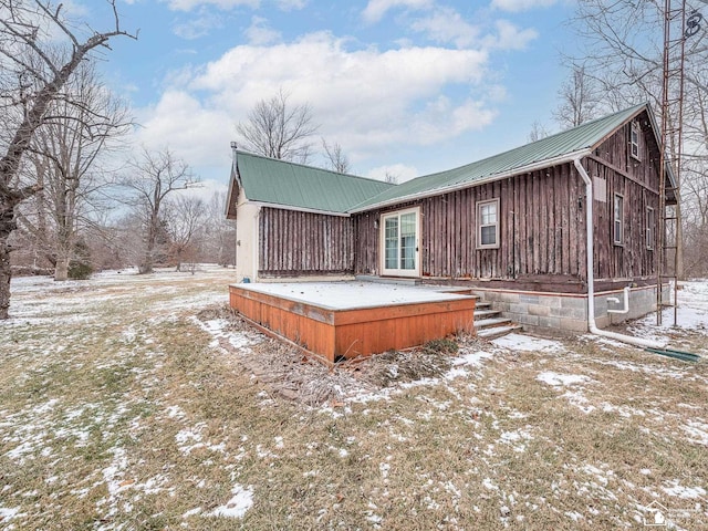 view of snow covered back of property