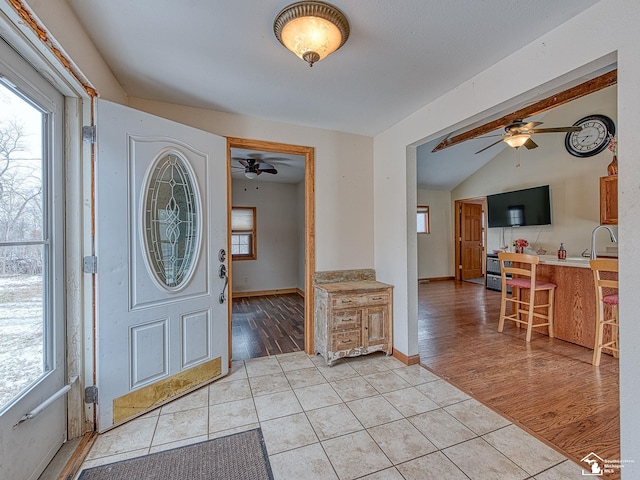 foyer entrance featuring light tile patterned floors and sink