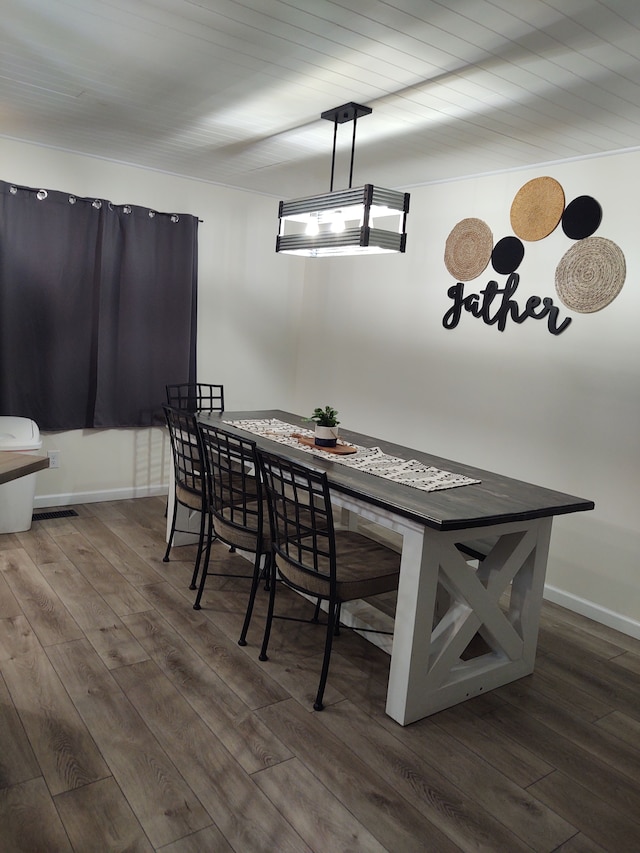 dining area with dark wood-type flooring