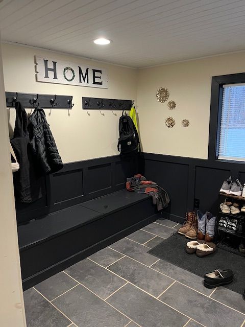 mudroom featuring dark tile patterned flooring