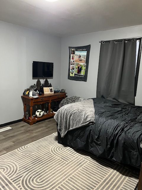 bedroom with hardwood / wood-style flooring