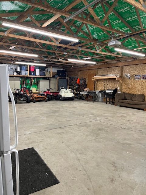 garage with white refrigerator and a garage door opener