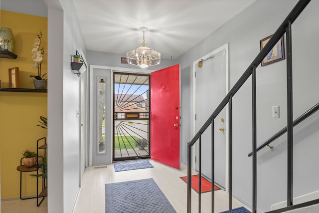 entryway featuring a notable chandelier and light hardwood / wood-style floors