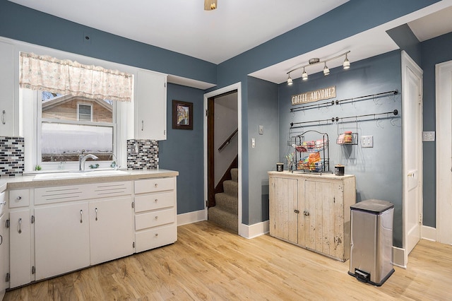 interior space with hardwood / wood-style floors, backsplash, and sink