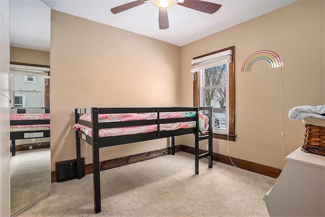 bedroom featuring light colored carpet and ceiling fan