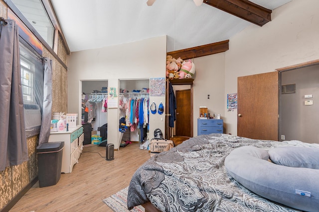 bedroom featuring vaulted ceiling with beams, ceiling fan, and light hardwood / wood-style flooring