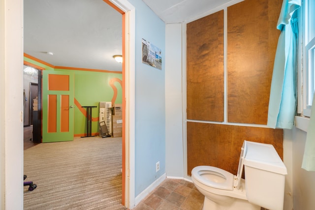 bathroom featuring toilet and crown molding