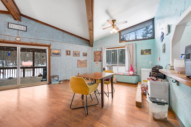 dining area featuring ceiling fan, beam ceiling, high vaulted ceiling, and light hardwood / wood-style flooring