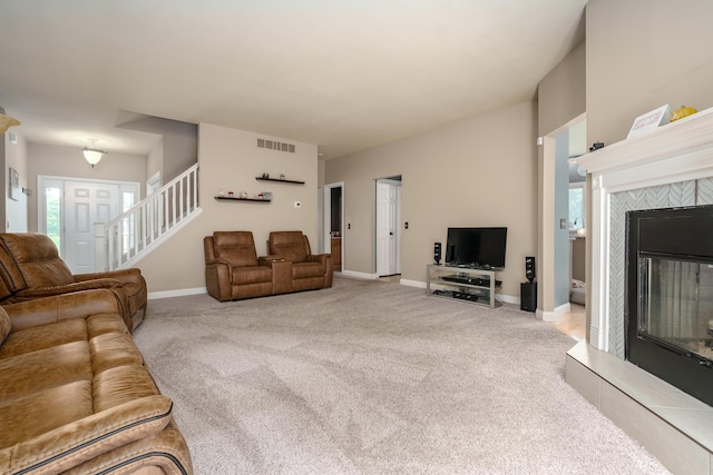 carpeted living room with a fireplace