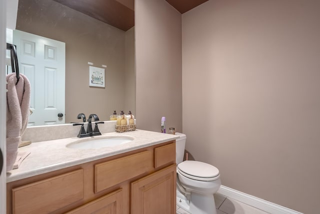 bathroom with tile patterned flooring, vanity, and toilet