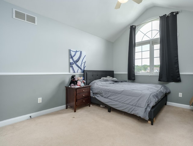 bedroom featuring ceiling fan, light colored carpet, and vaulted ceiling