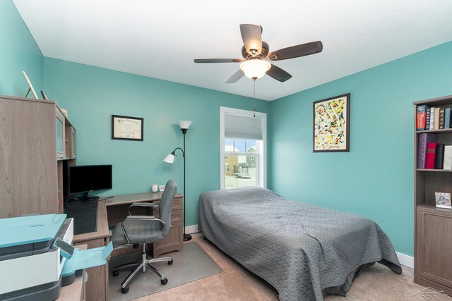 bedroom featuring ceiling fan and light carpet