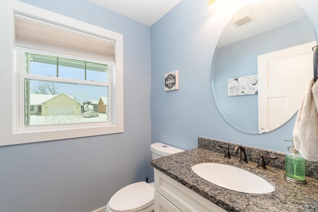 bathroom with vanity and toilet