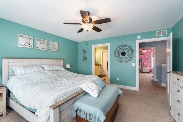 carpeted bedroom with connected bathroom and ceiling fan