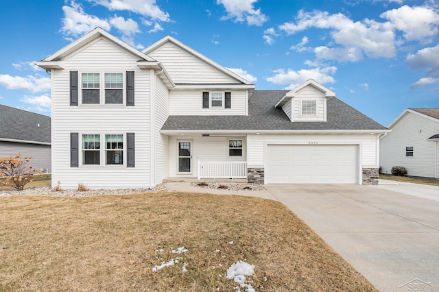 traditional home featuring driveway, a garage, a shingled roof, stone siding, and a front yard