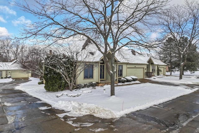 view of snowy exterior with a garage