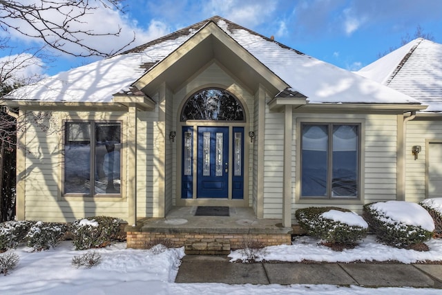 view of snow covered property entrance