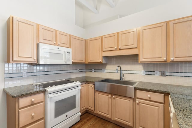 kitchen featuring light brown cabinetry, backsplash, white appliances, sink, and dark hardwood / wood-style floors