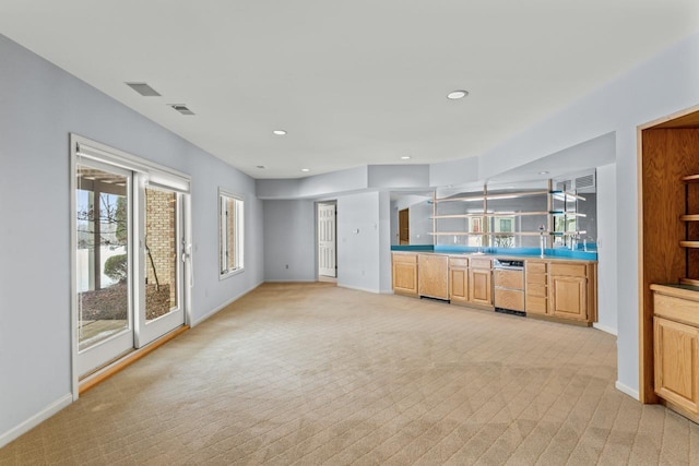 unfurnished living room with light colored carpet