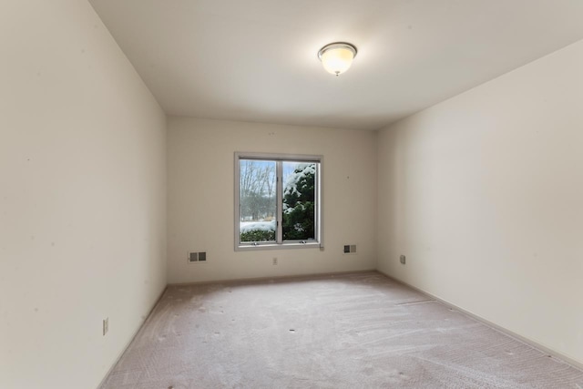 spare room with light colored carpet