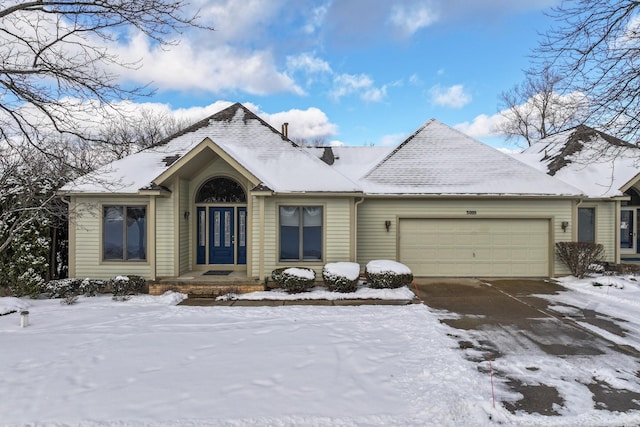 ranch-style home featuring a garage and driveway