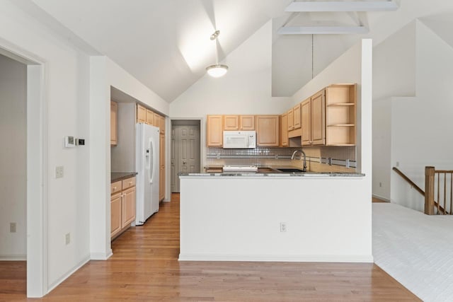 kitchen featuring sink, backsplash, kitchen peninsula, white appliances, and light brown cabinetry